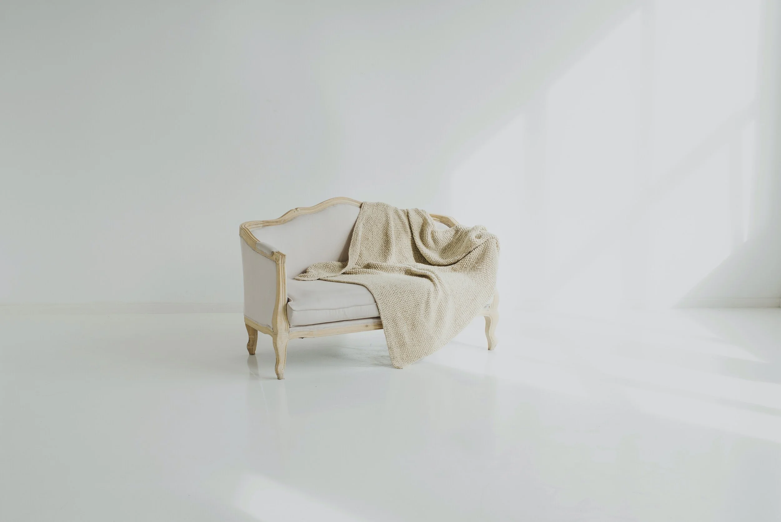 white-towel-on-white-wooden-sofa-3965534.jpg