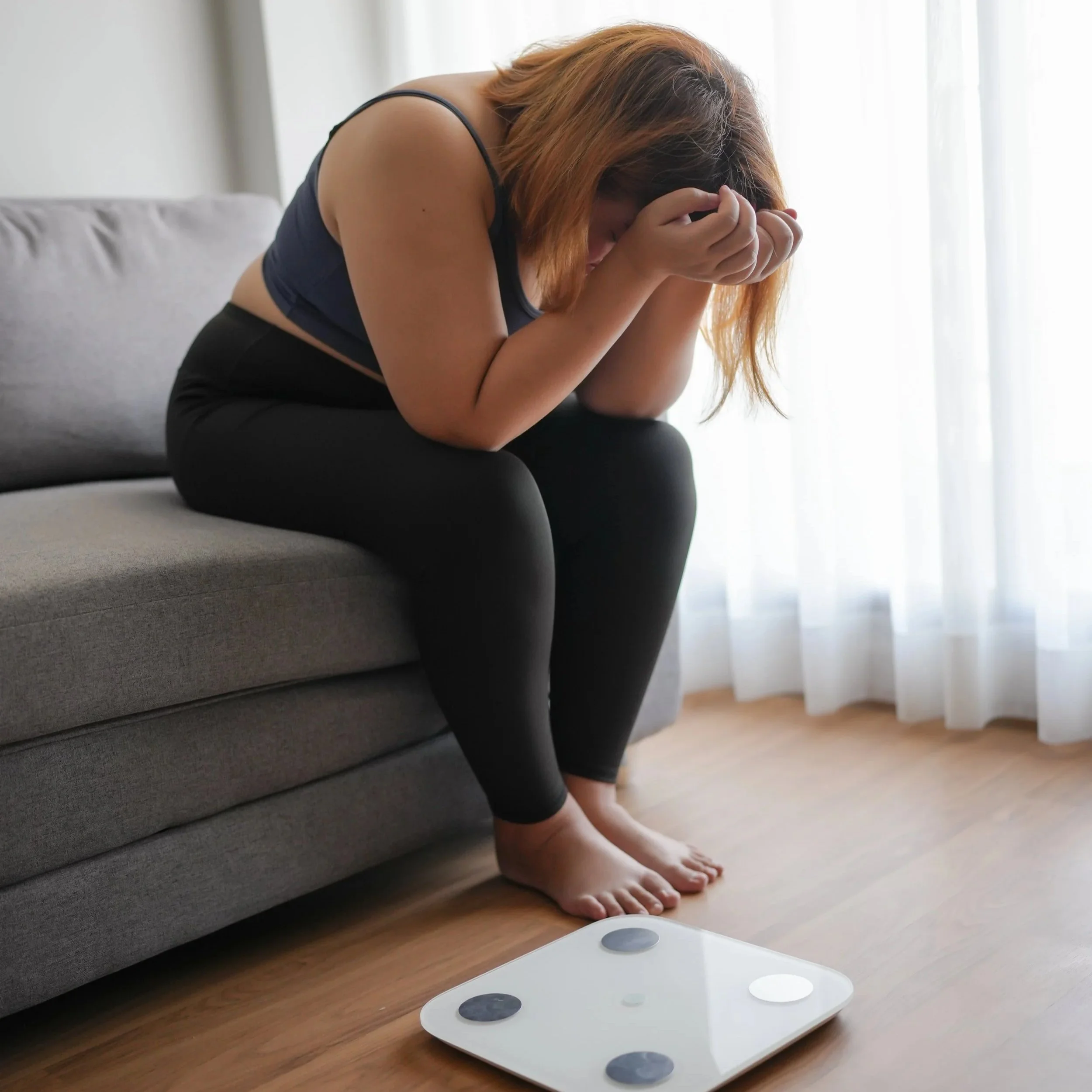 Person experiencing frustration with stalled weight loss despite consistent effort