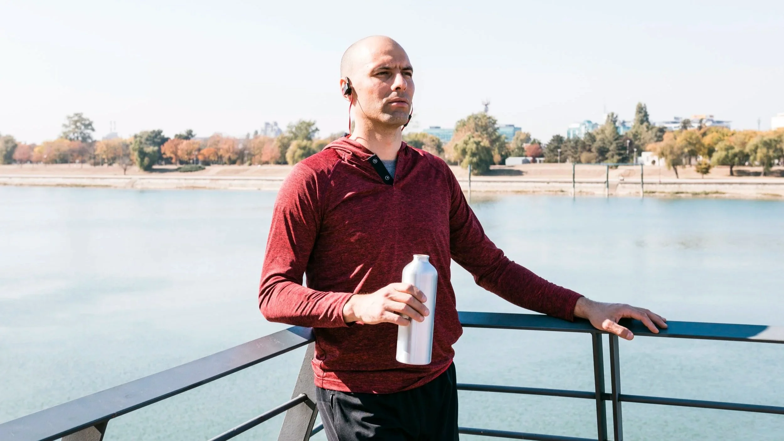 Professional adult resting after light exercise in natural light, appearing calm and reflective