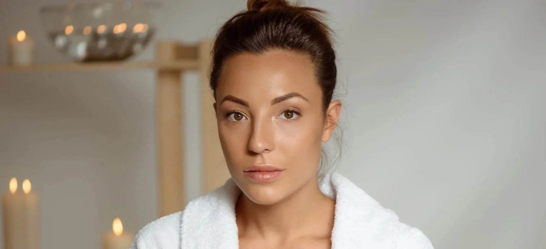 Woman in a wellness setting representing improved facial circulation and skin glow.