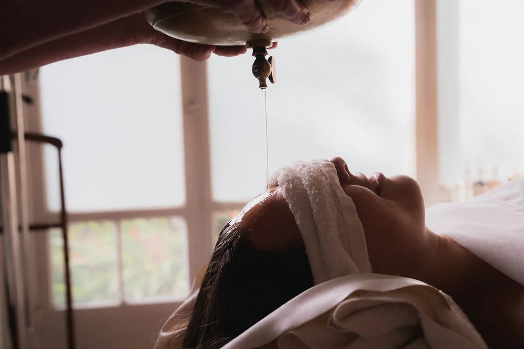 Maharani Academy student is receiving a Shirodhara treatment.jpg