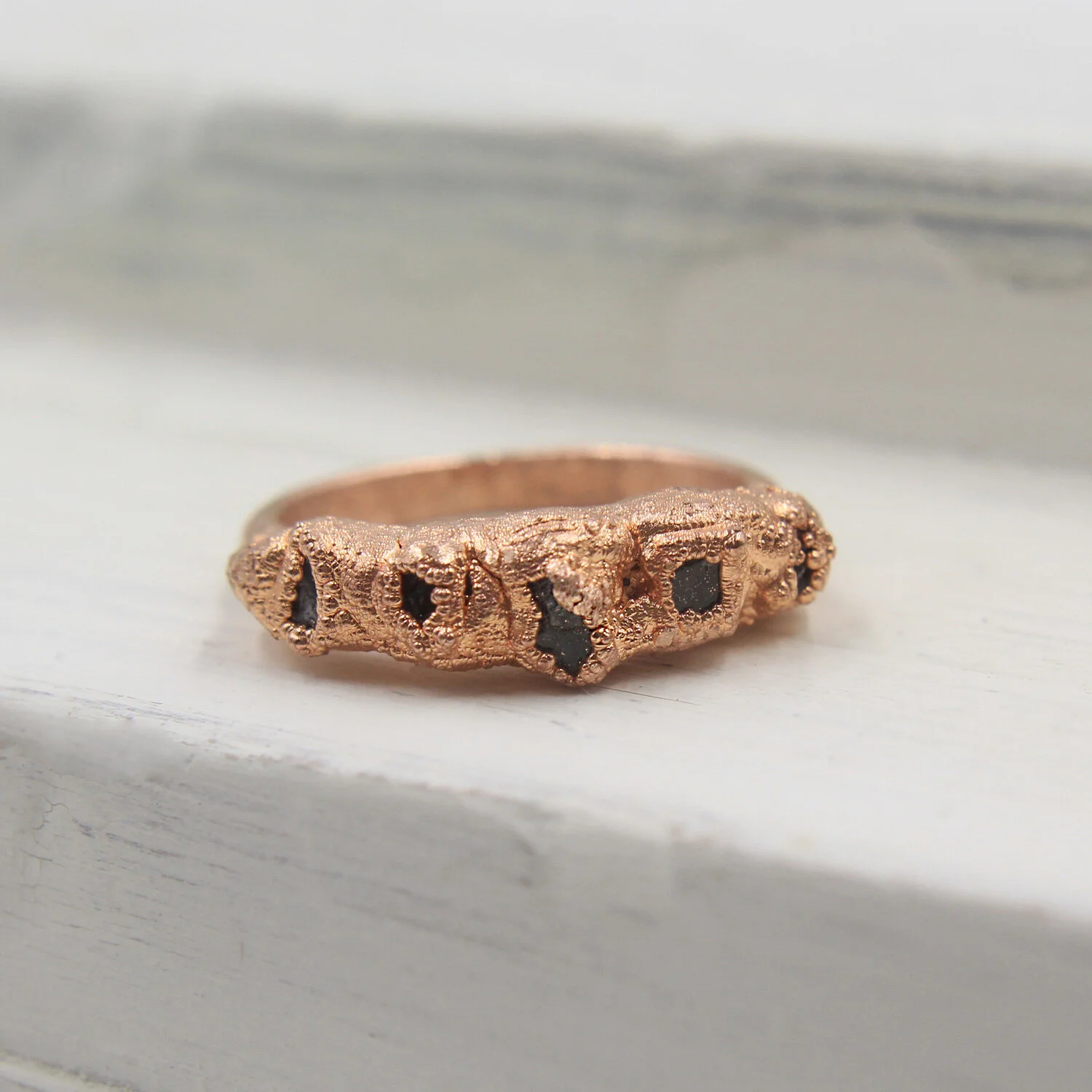 Sapphire five-stone electroformed copper ring on display