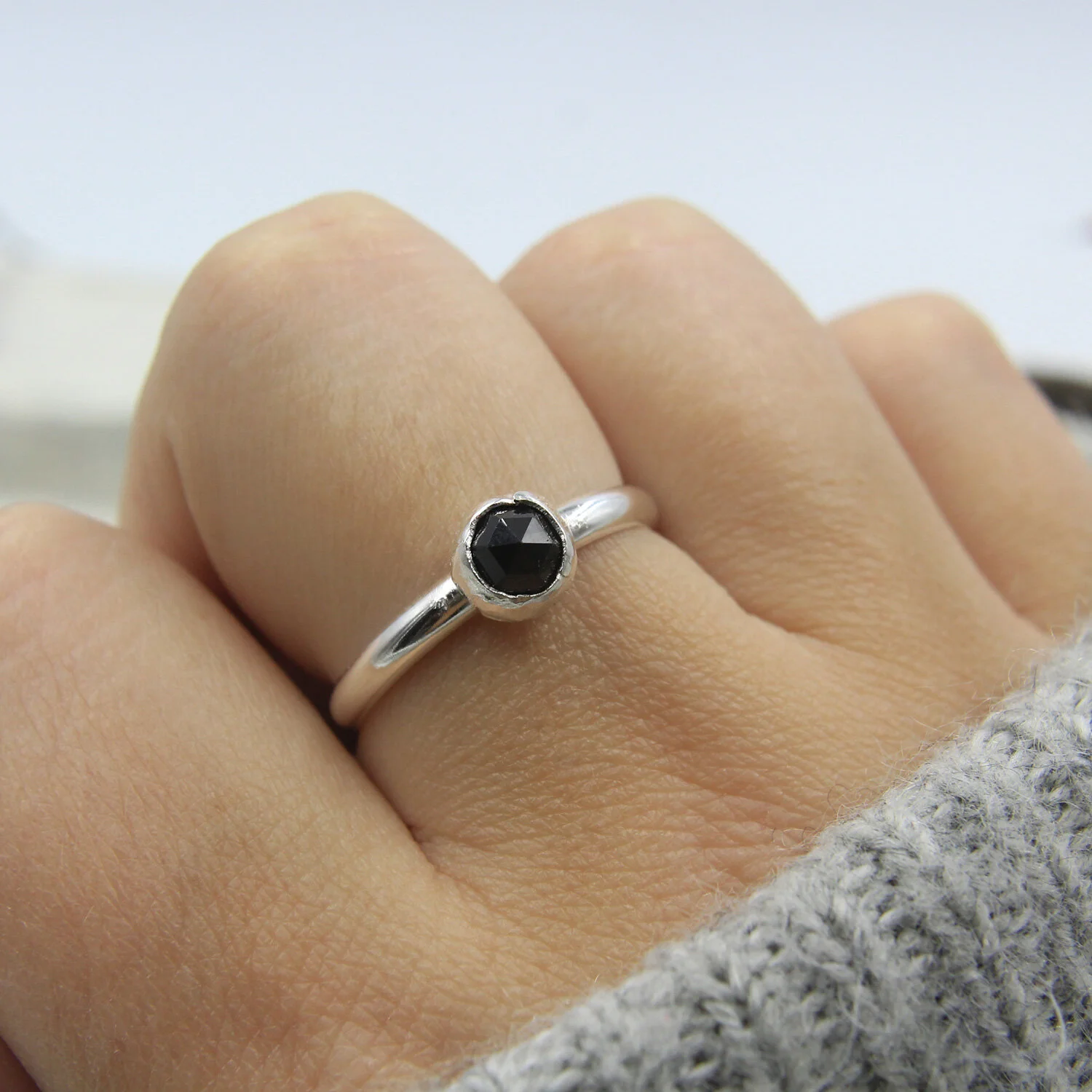 Black spinel sterling silver ring on hand