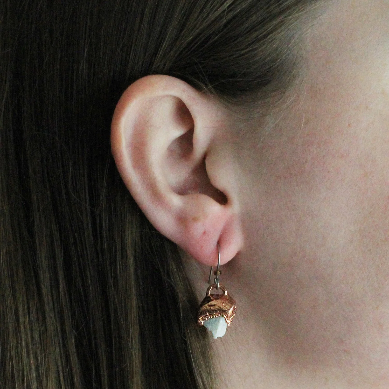 Raw aquamarine electroformed copper drop earrings being worn