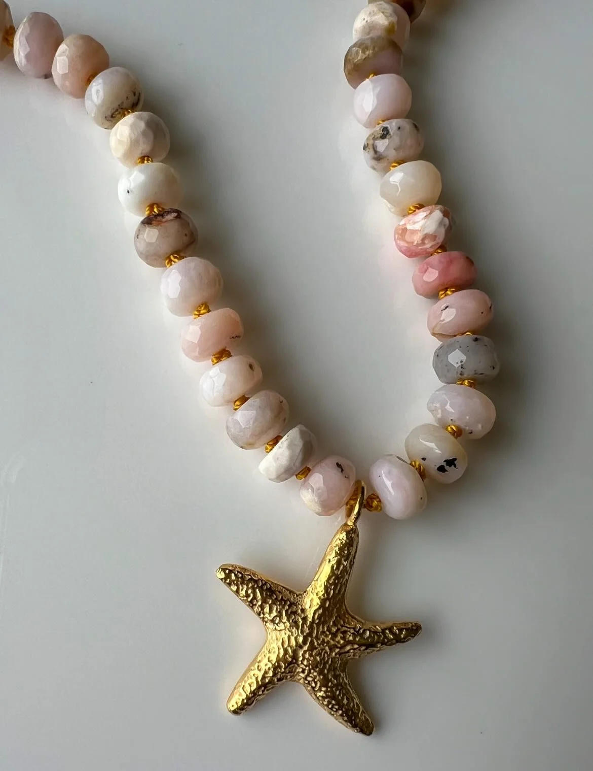 I adore these natural pink , undyed , Opal beads. Teamed with gold vermeil clasps and a starfish that I have hand carved and cast. Delish. One of a kind 🩷

#zaratahirjewellery
#opalnecklace
#starfishnecklace 
#naturalgemstones