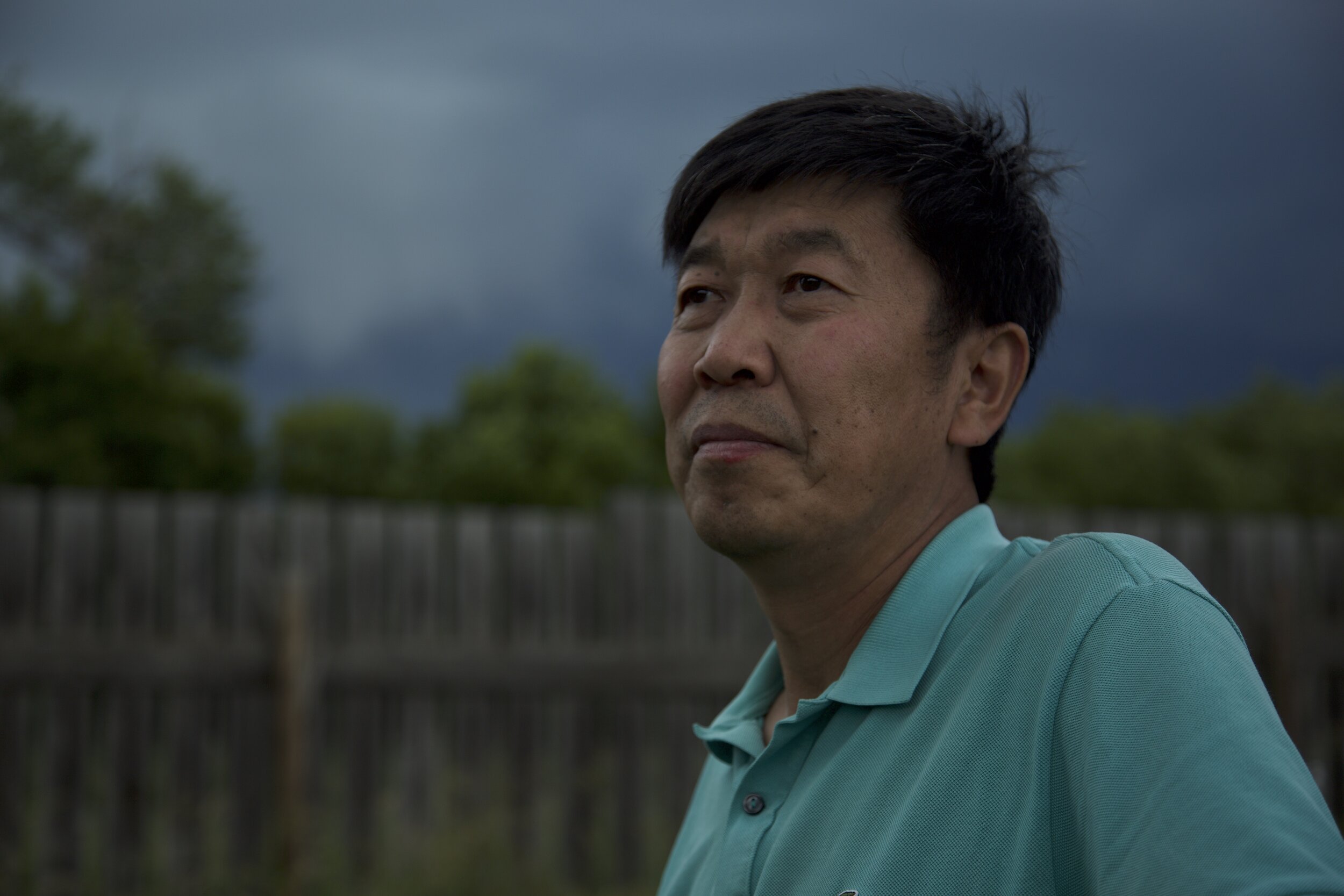Farmland - David Fu looking at the fields before a storm, with the future of his farm uncertain.jpg