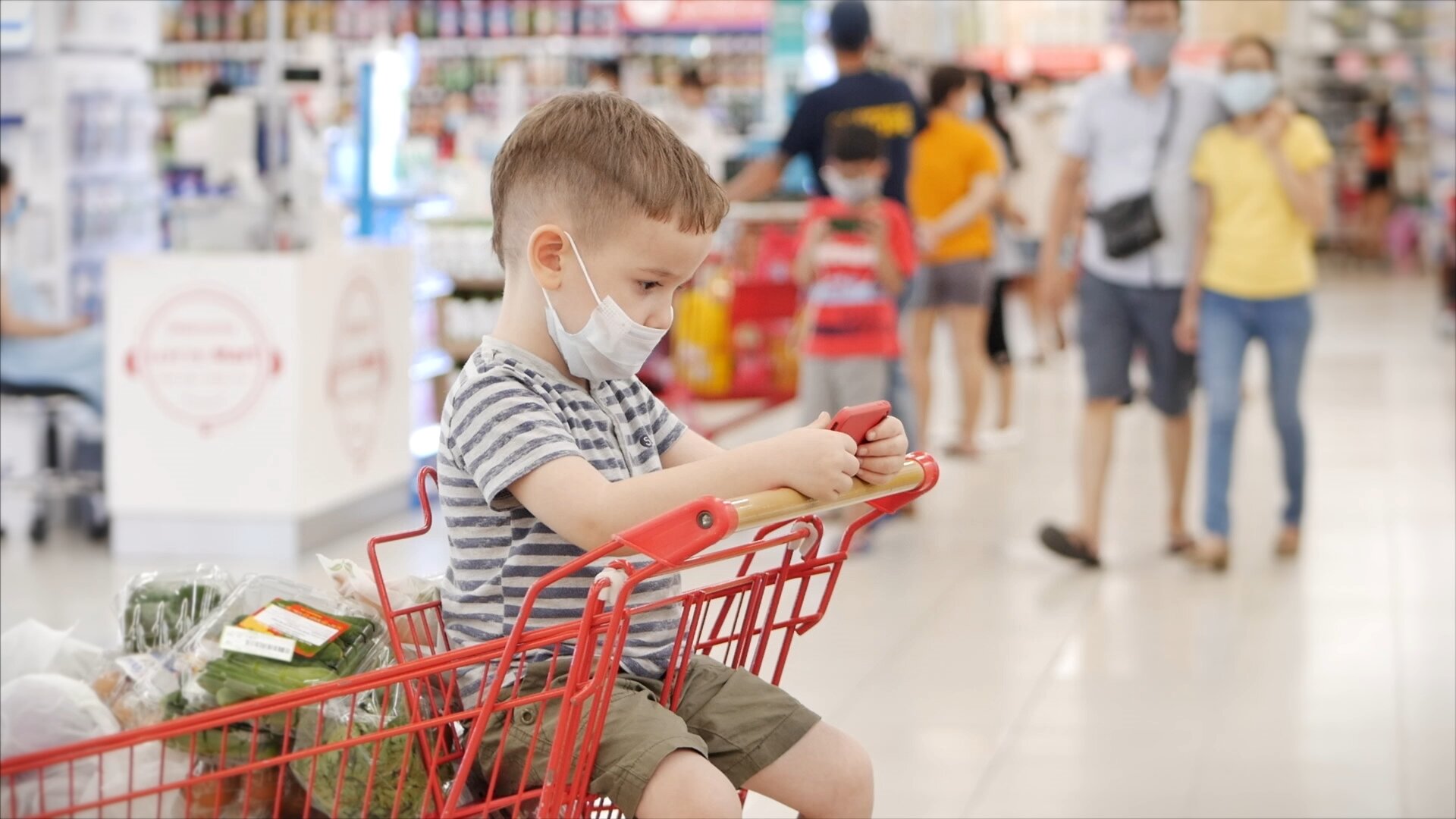little boy with mask in grocery cart_shutterstock_1049788066 copy.jpg