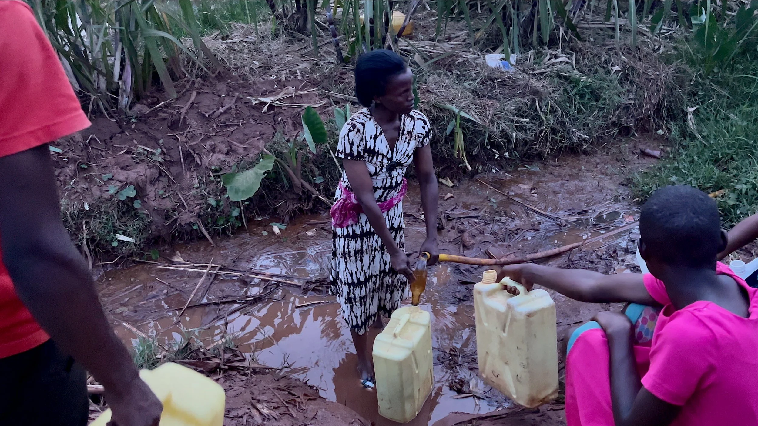 The-Struggle-for-Mother-Water-Fetching-Water-Filling-Jerry-Cans-Rwanda.jpg