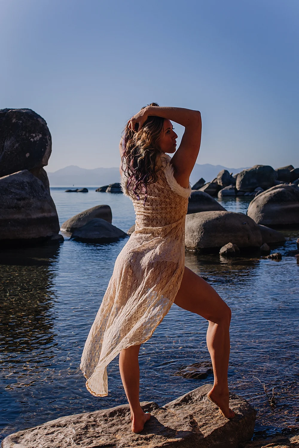 boudoir-image-0f-woman-in-lace-robe-poses-next-to-lake-tahoe.jpg