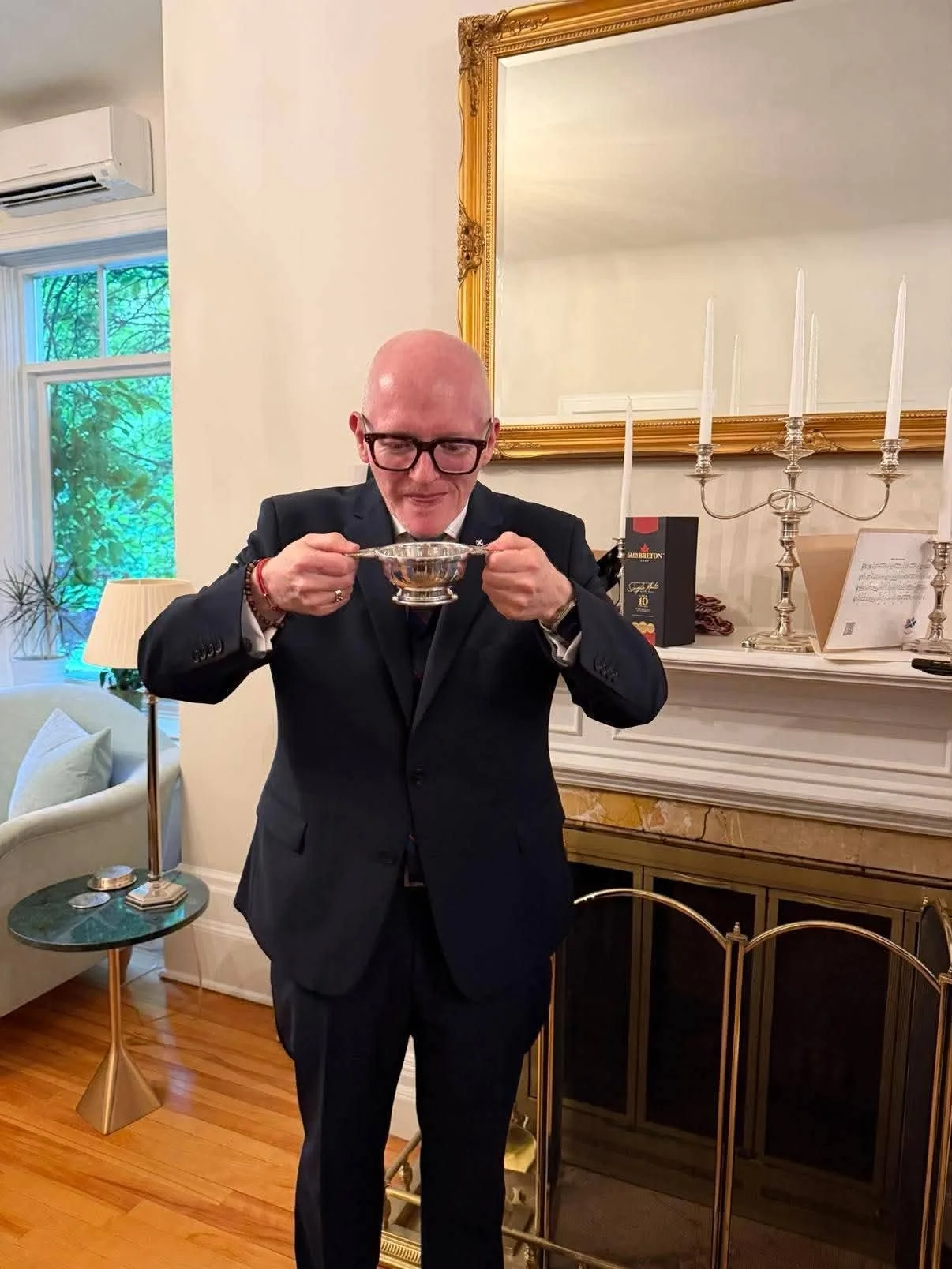 John Devine drinking from his quaich