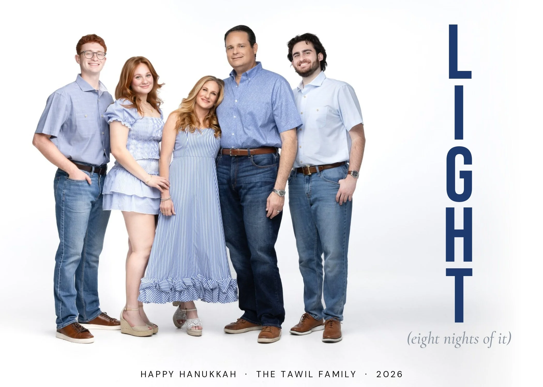 Custom Hanukkah card with LIGHT stacked vertically in navy blue beside a family of five in matching blue on a white studio backdrop, McAllen TX family photographer