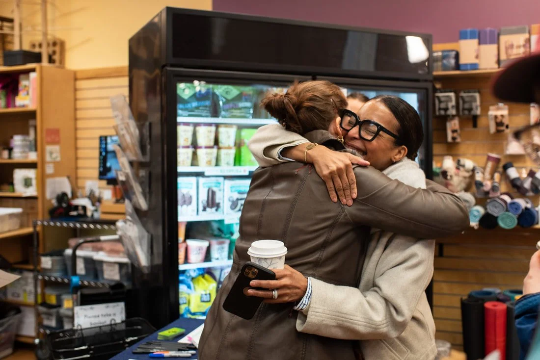  Folks networking and joining in on a B Corp scavenger hunt at Cambridge Naturals for a B Local Boston event 