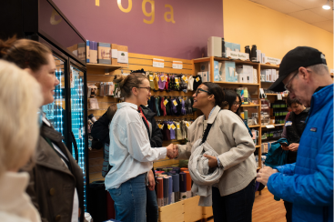 Folks networking and joining in on a B Corp scavenger hunt at Cambridge Naturals for a B Local Boston even