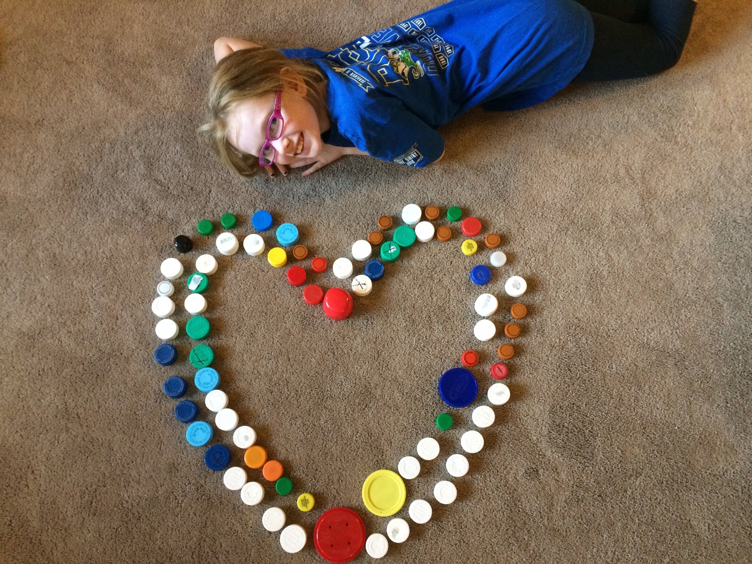 Sammie with caps in a heart.JPG