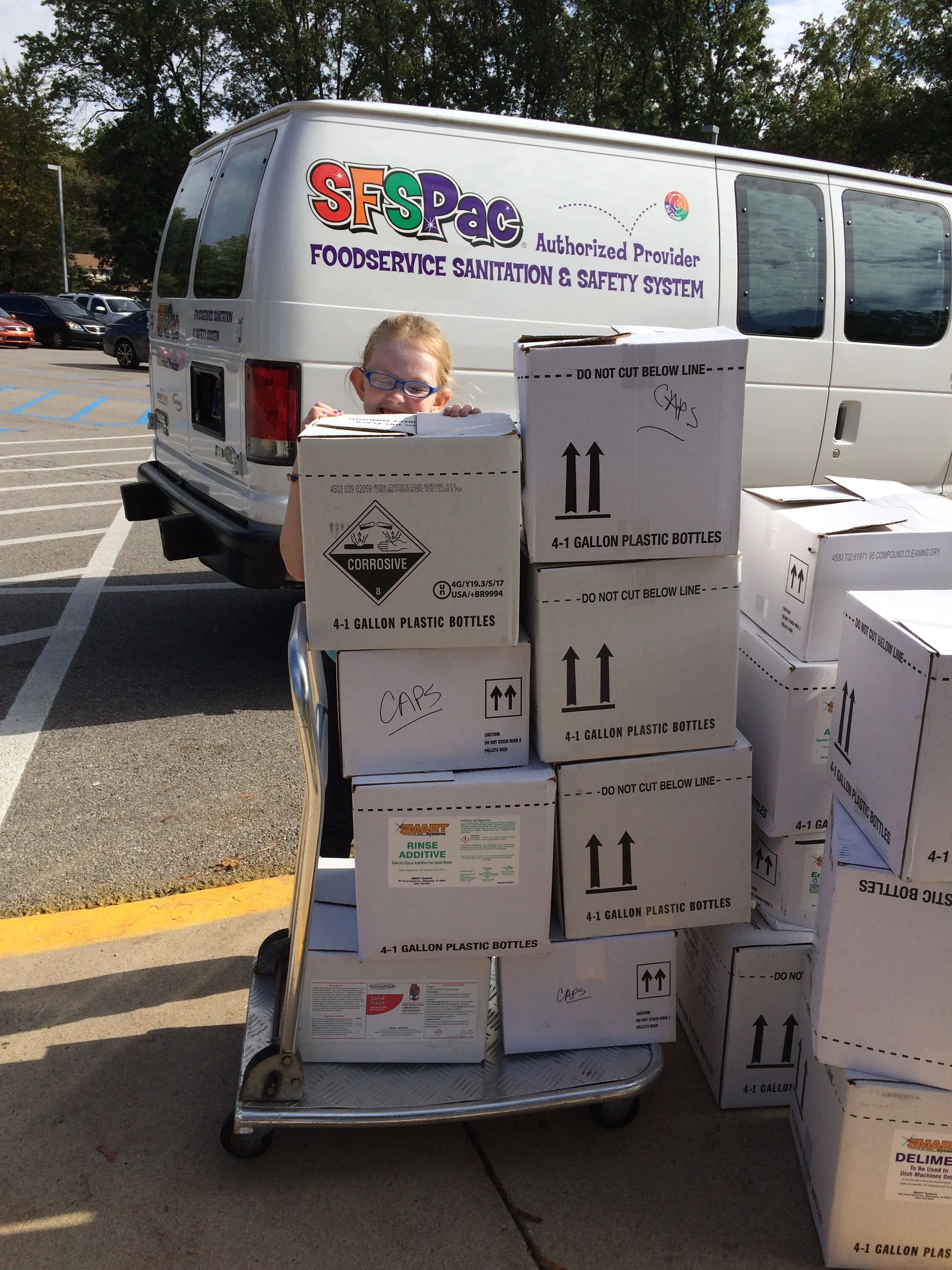 boxes of caps taller than sammie.JPG