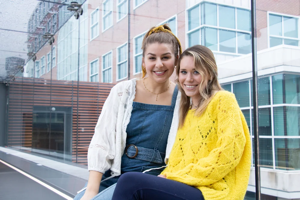 Sarah Madaus (REFINE Editor-in-Chief) and Claire Wolters (Intersection Editor) photographed in the Alter Hall Skywalk. | HANNAH PITTEL / REFINE MAGAZINE