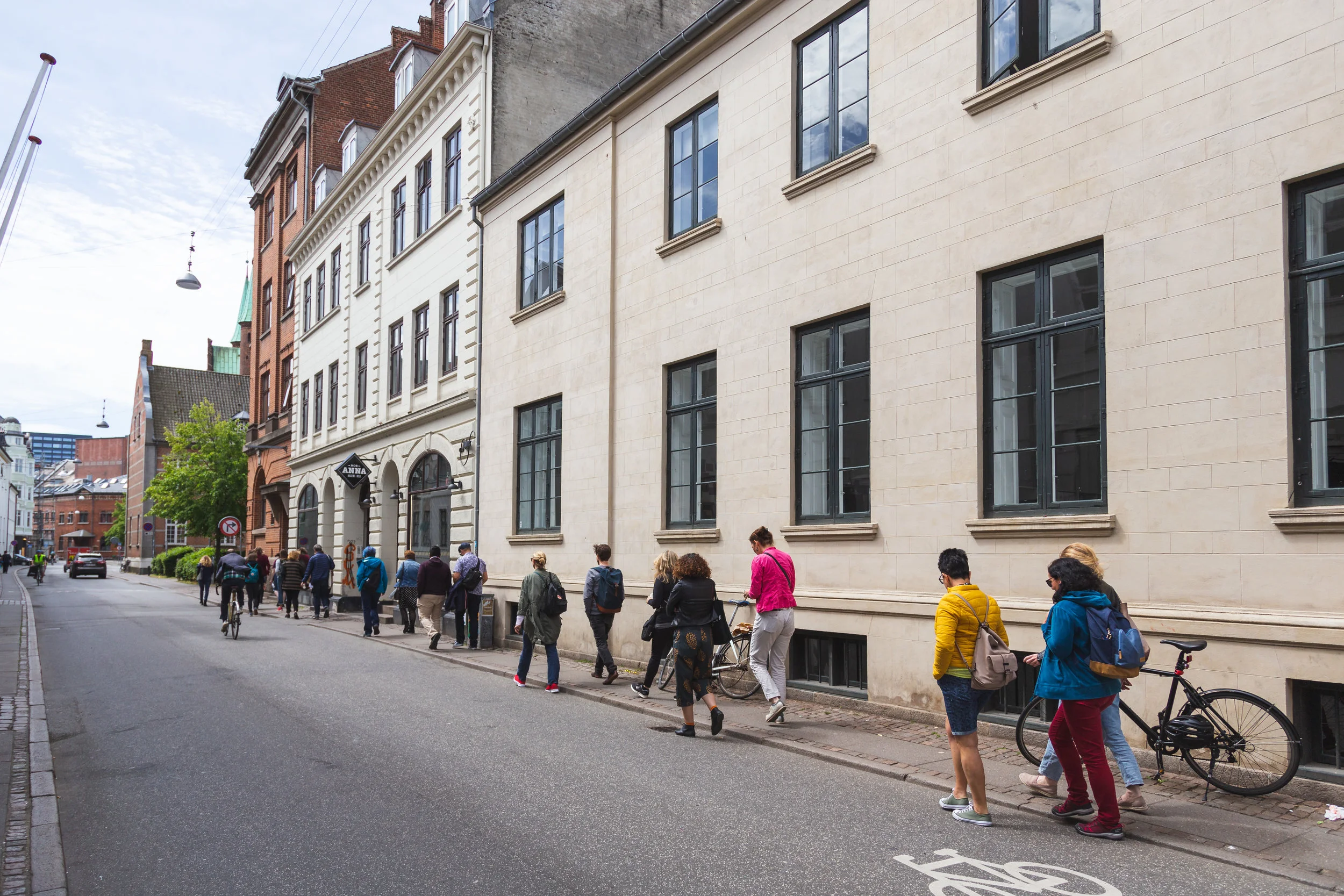 7. During inspiration tours, people tend to walk in groups of 2 and 3. As we walked through the streets of Aarhus there were rich conversations about their lives and work - many people who had never met felt a strong sense of connection to others in the group. A big part of this experiences was to connect with other people through exploration. We also encouraged the group to think of themselves as a walking sculpture - that we are all creating and building something together. In this image, we are walking from lunch to the Botanical Garden.