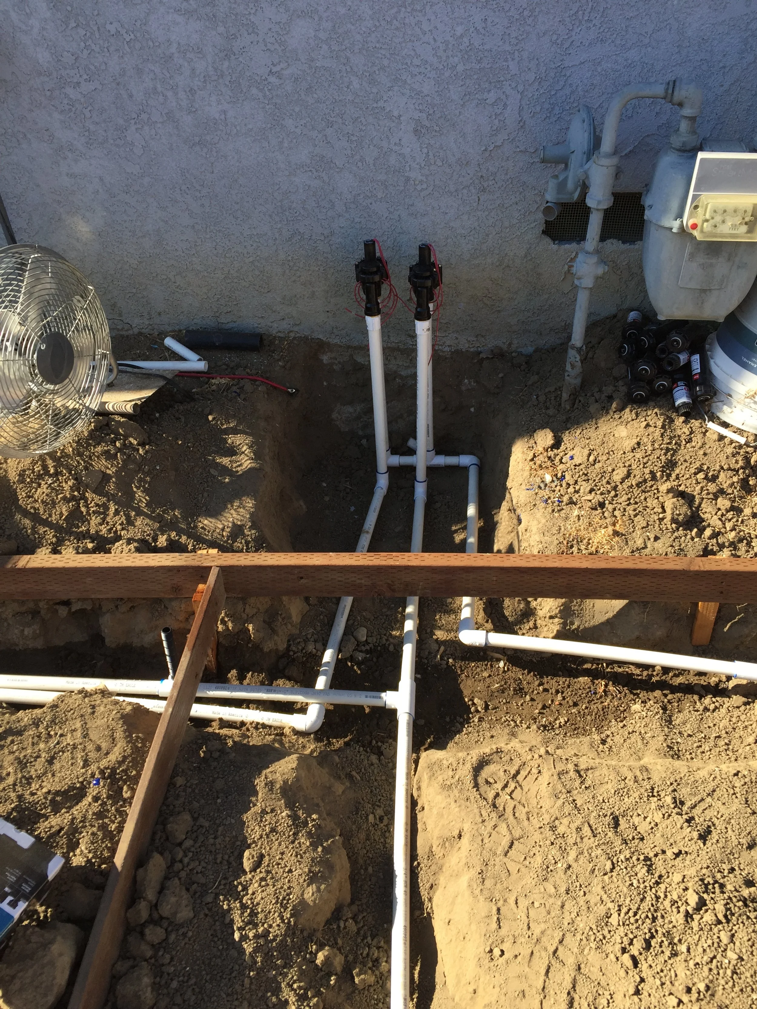 Underground plumbing pipes and water meters installation in a construction site.