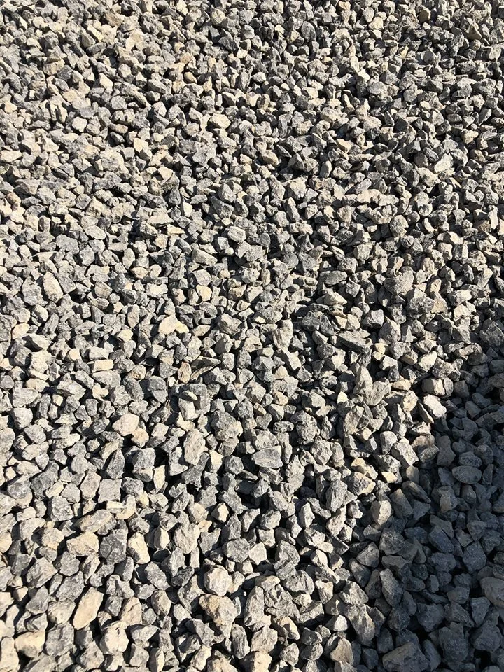 A close-up view of small gray gravel stones spread across the ground.