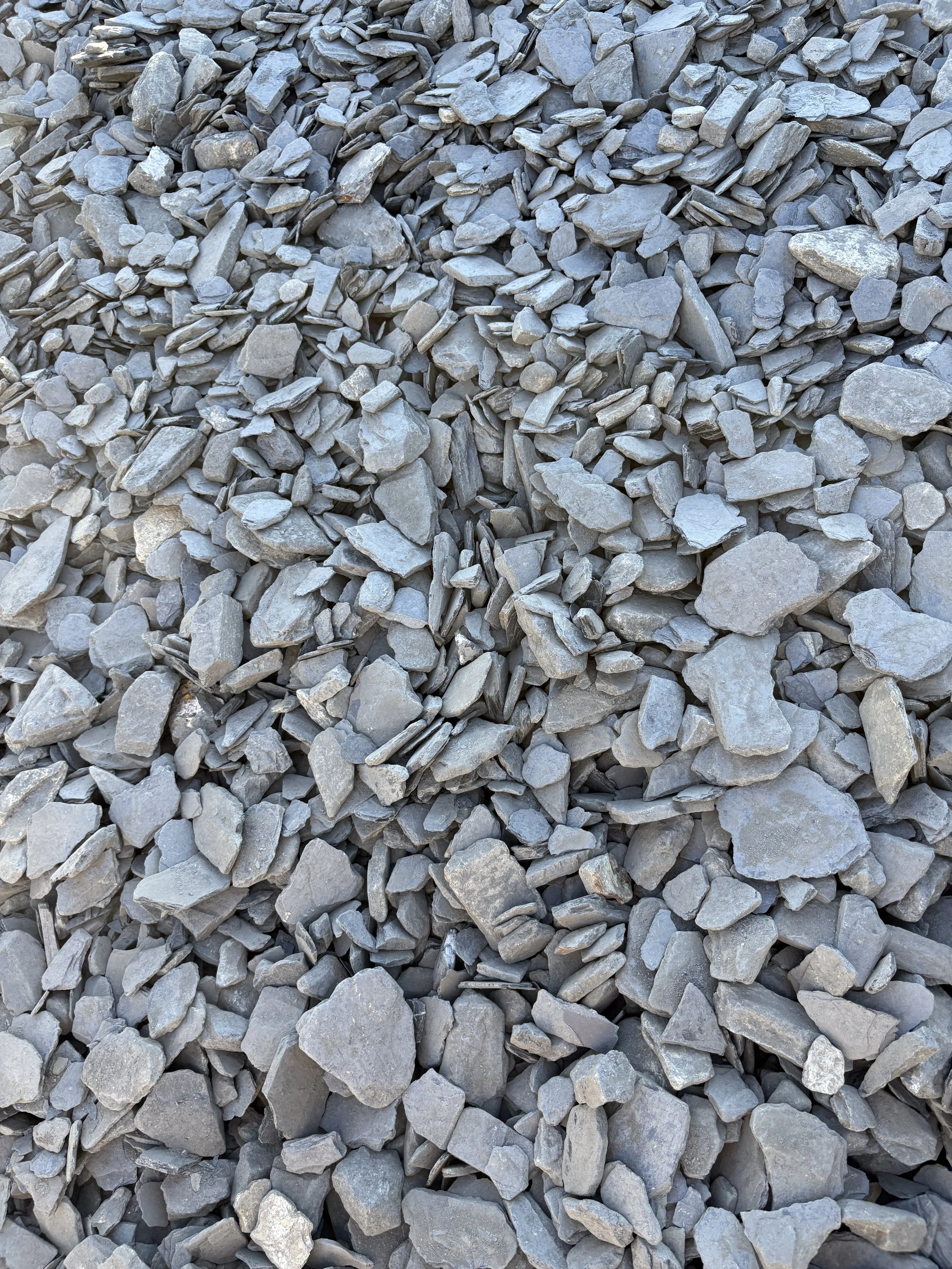 A large pile of gray crushed stones or gravel.