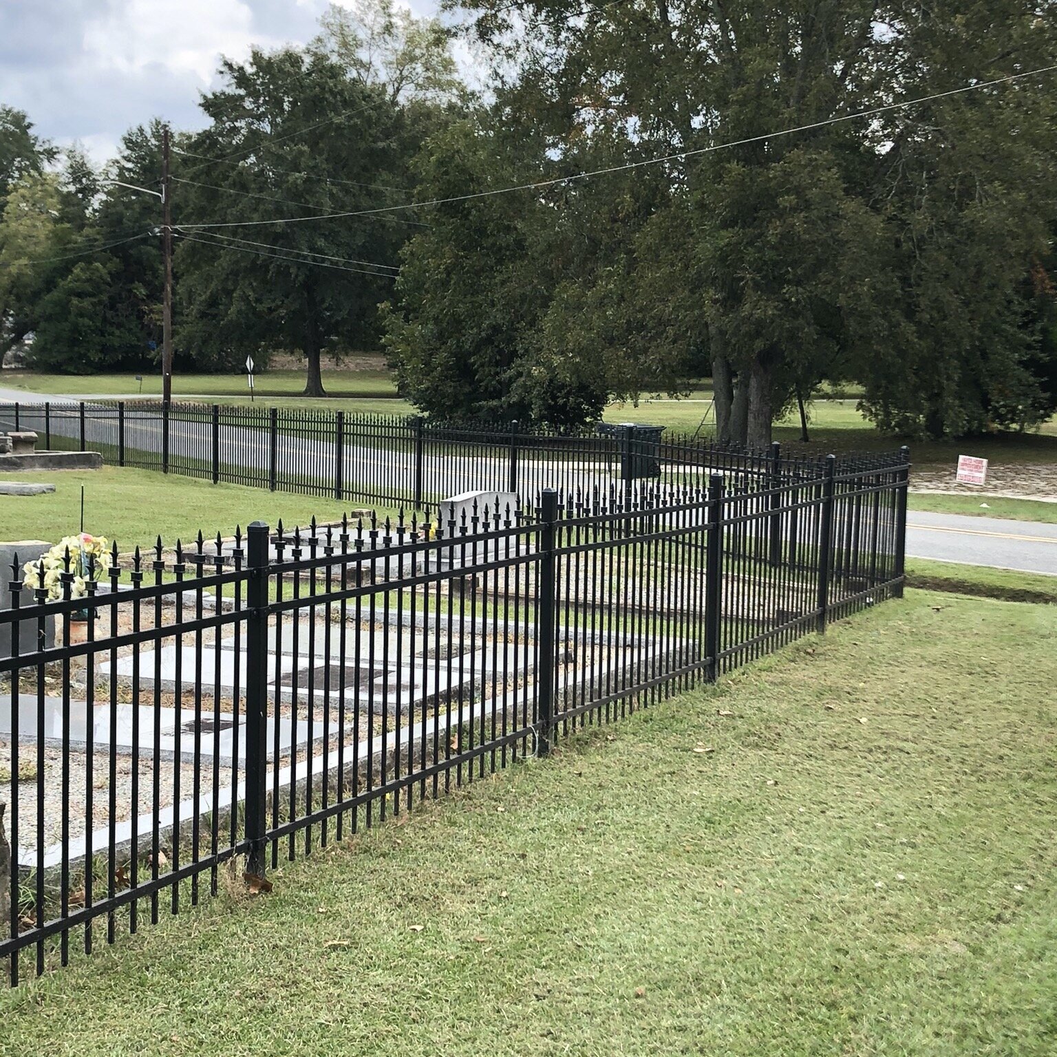 Ornamental steel perimeter fence for a cemetery.