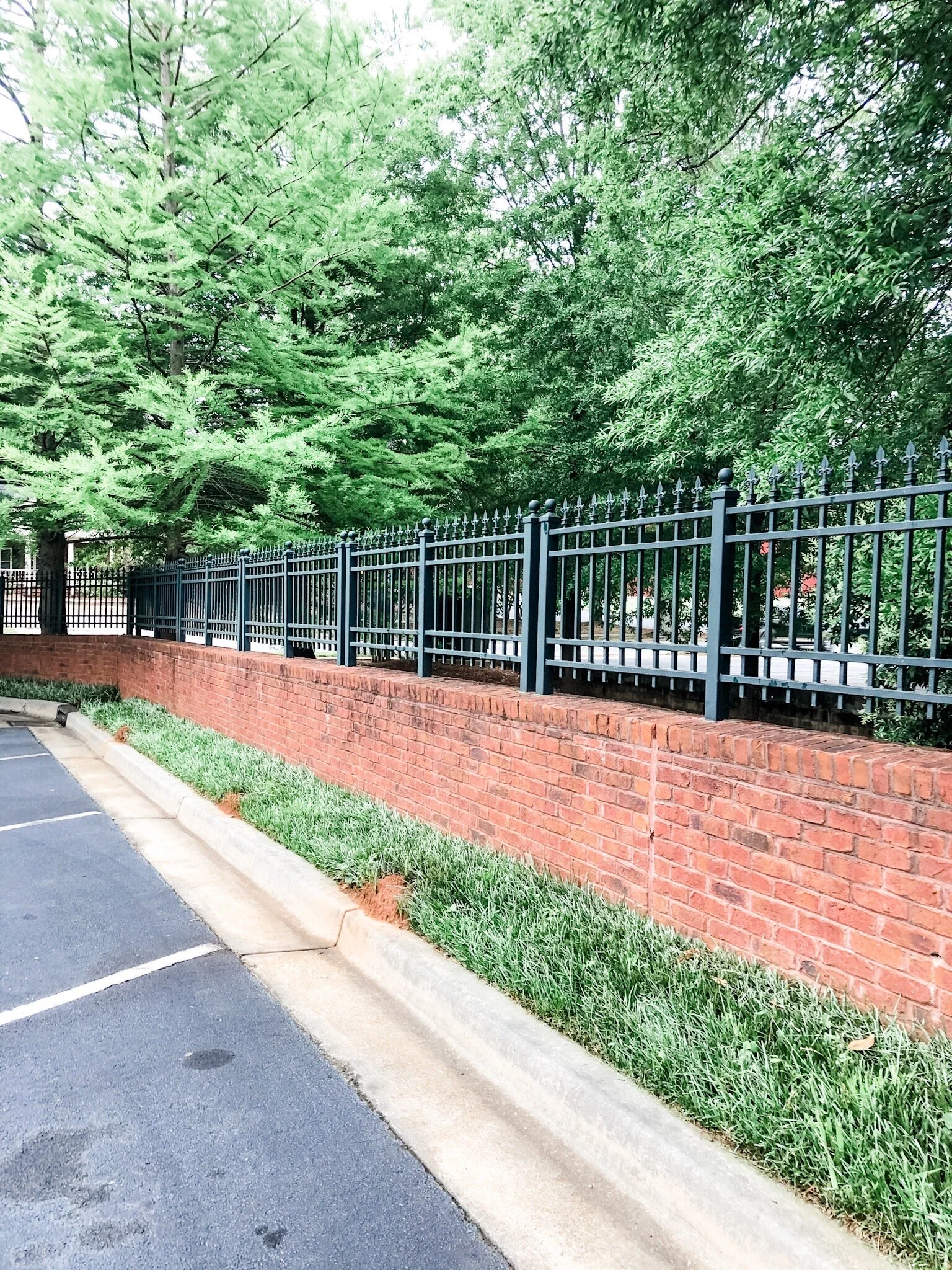 ornamental steel aluminum iron fence brick retaining wall.jpeg