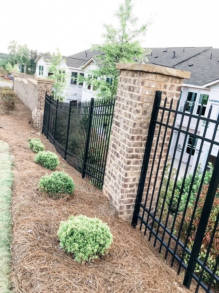 ornamental steel aluminum fence with brick columns.jpeg