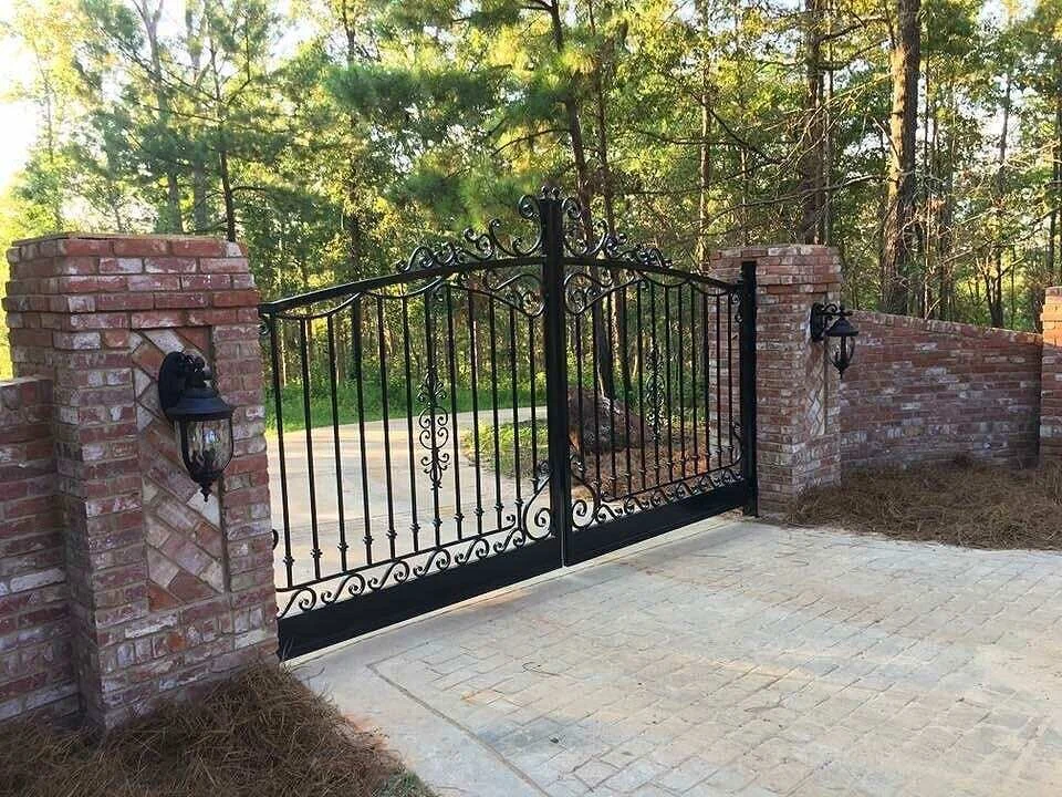 Ornamental double driveway gate between brick columns