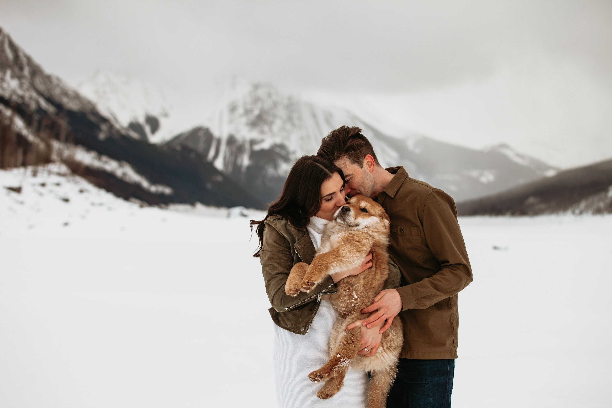 Couple cuddling their dog at Medicine Lake | Jamie Robson Photography | Engagement Photographer in Jasper (Copy)