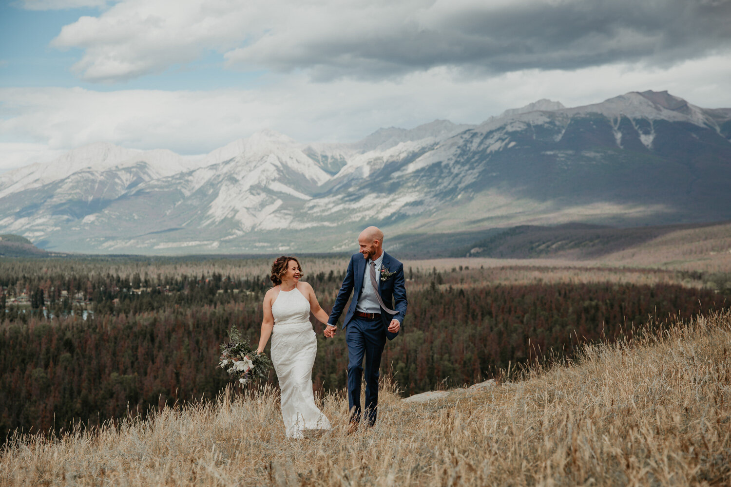 Bride & Groom walking on mountaintopBride & Groom in the Rocky Mountains | Jamie Robson Photography | Elopement & Wedding Photographer in Jasper (Copy)