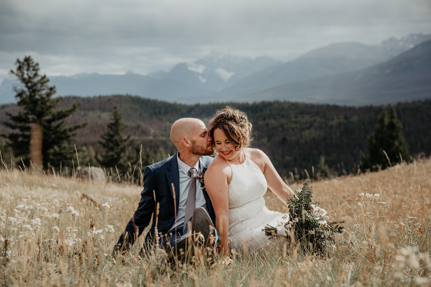 Bride & Groom snuggling on mountaintopBride & Groom in the Rocky Mountains | Jamie Robson Photography | Elopement & Wedding Photographer in Jasper (Copy)