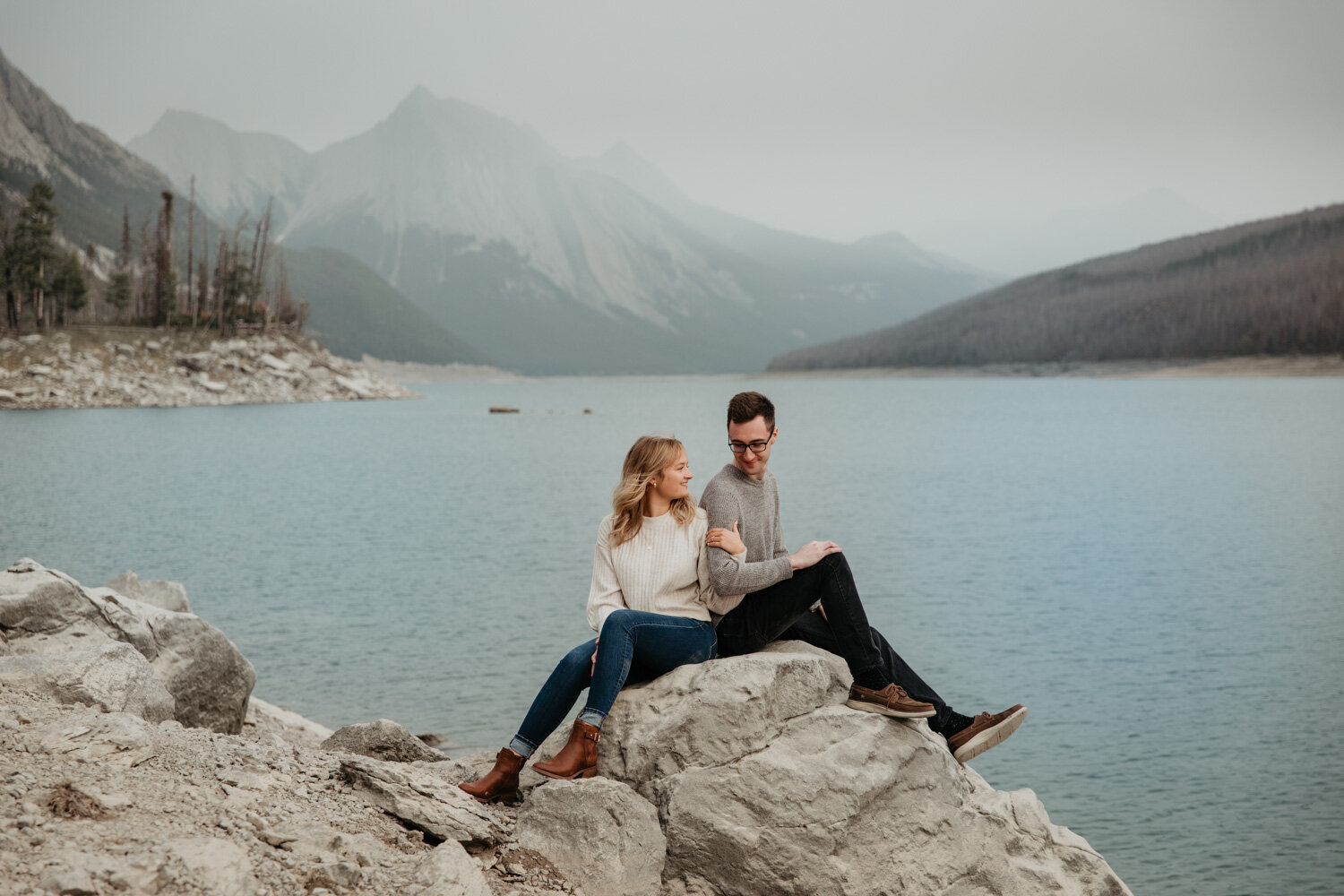 Couple sitting on a rock | Jamie Robson Photography | Engagement Photographer in Jasper (Copy)