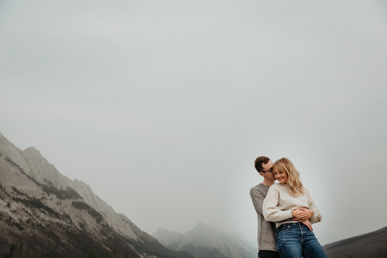 Couple cuddling in the mountains  | Jamie Robson Photography | Engagement Photographer in Jasper (Copy)