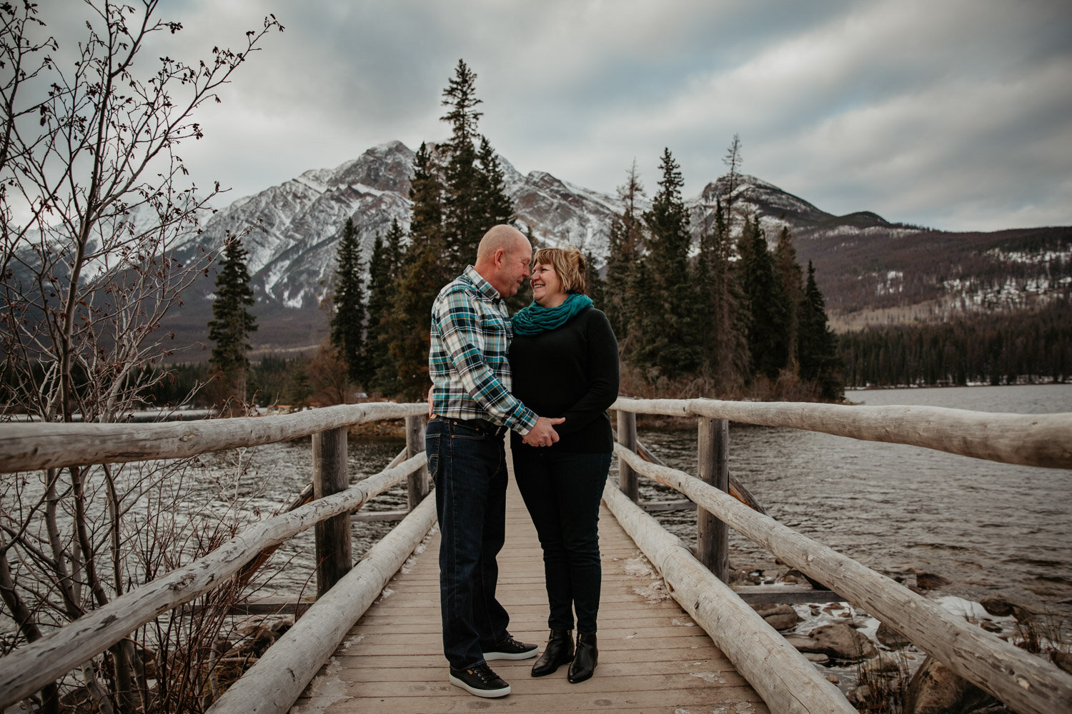 Couple standing on Pyramid Island Bridge | Jamie Robson Photography | Engagement Photographer in Jasper (Copy)