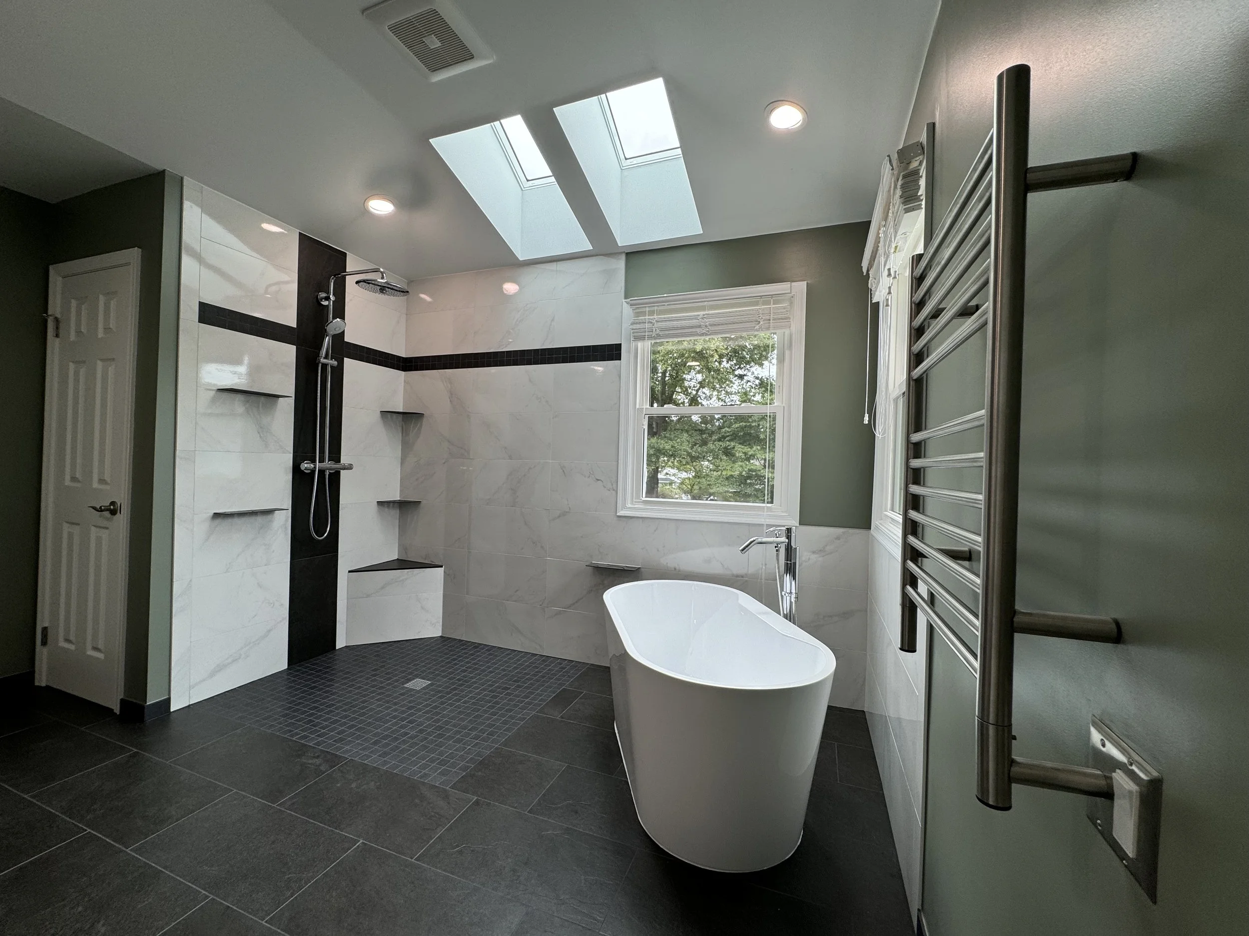 Custom bathroom remodel in Lower Makefield, PA featuring a freestanding tub walk in shower and large format tile