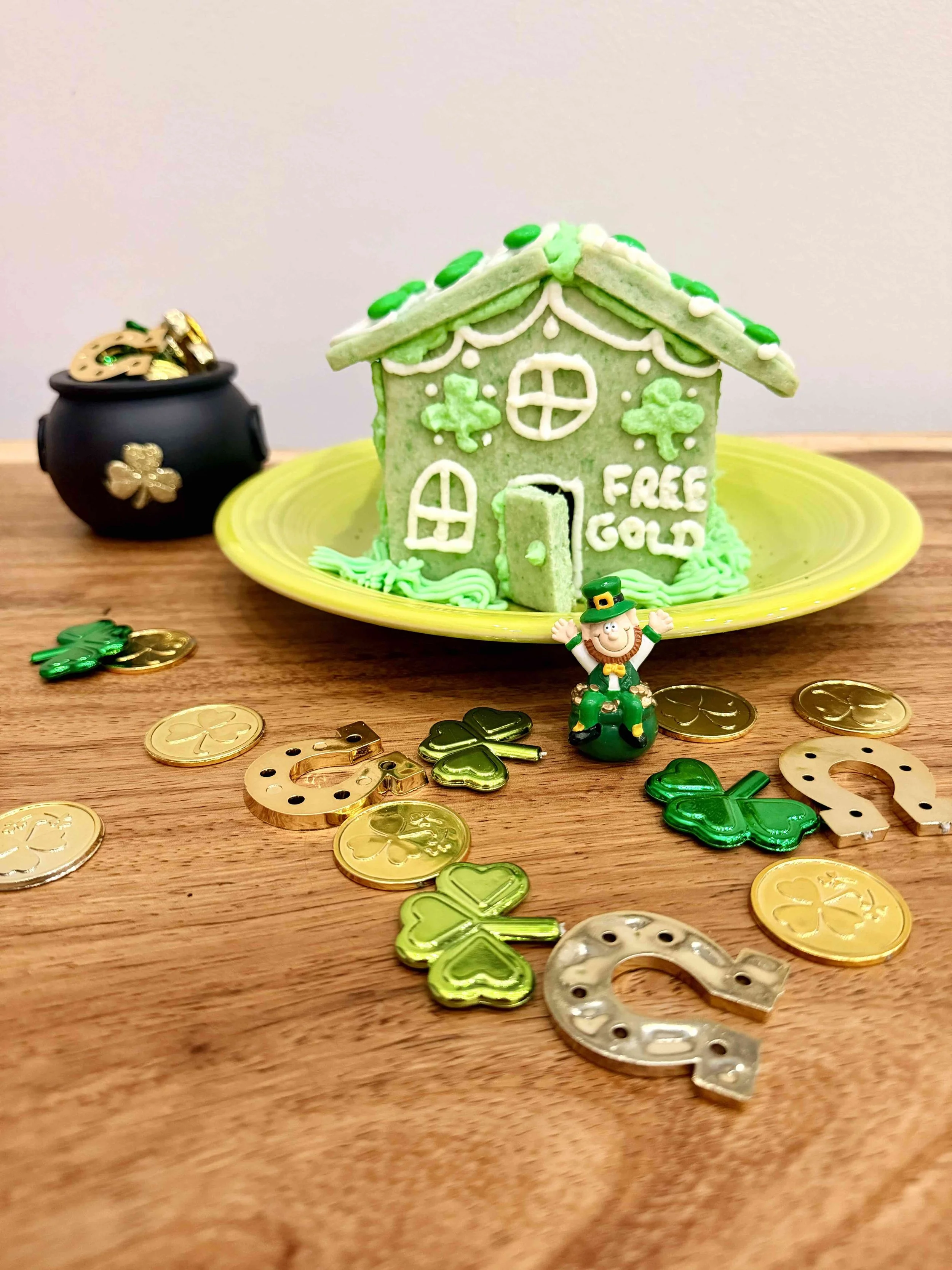 Chocolate gold coins placed outside a sugar cookie house leprechaun trap for St. Patrick’s Day.