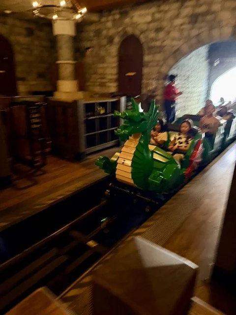 The Dragon roller coaster train entering the castle at LEGOLAND California