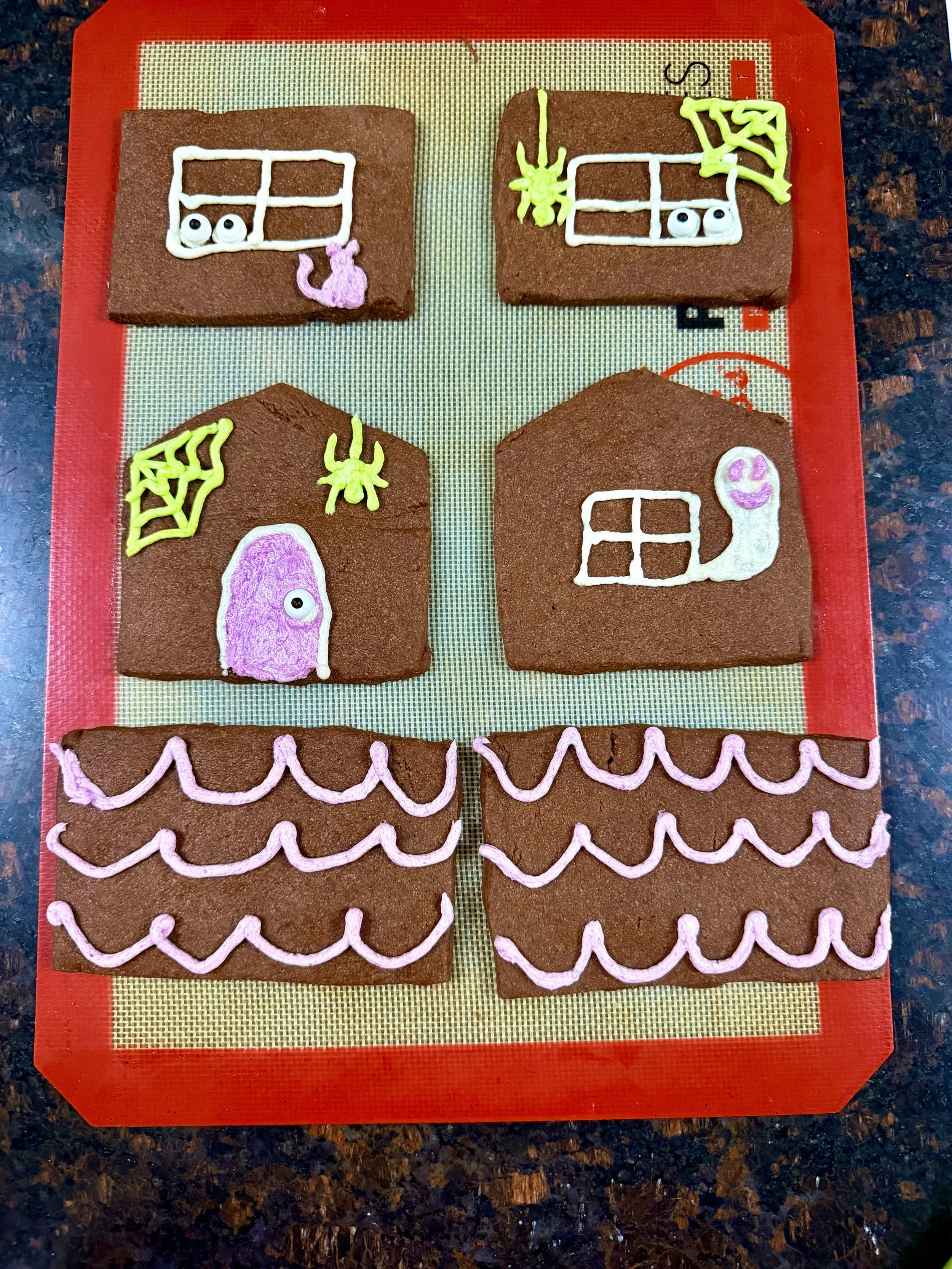 Decorate frosting on house pieces before assembly