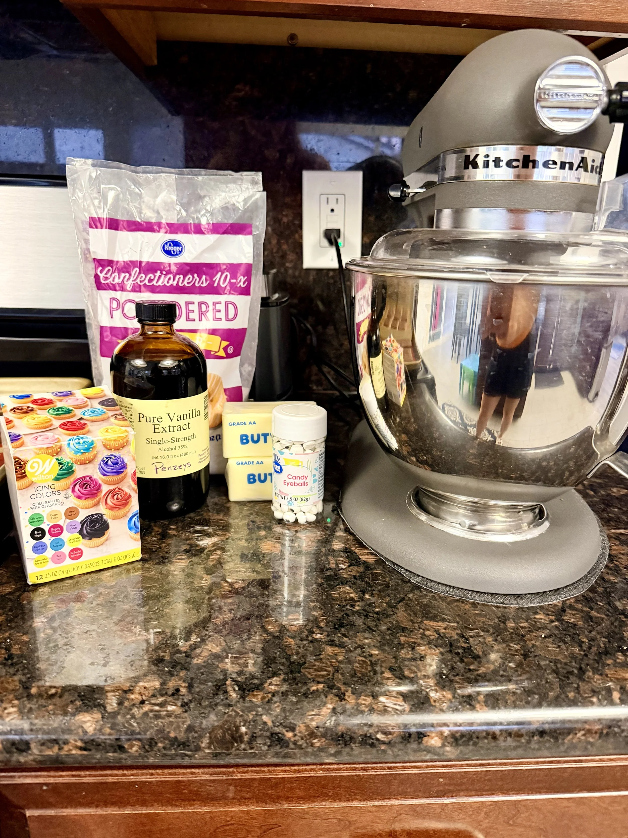 Buttercream frosting ingredients in front of a kitchen aid mixer for Halloween Haunted Cookie House