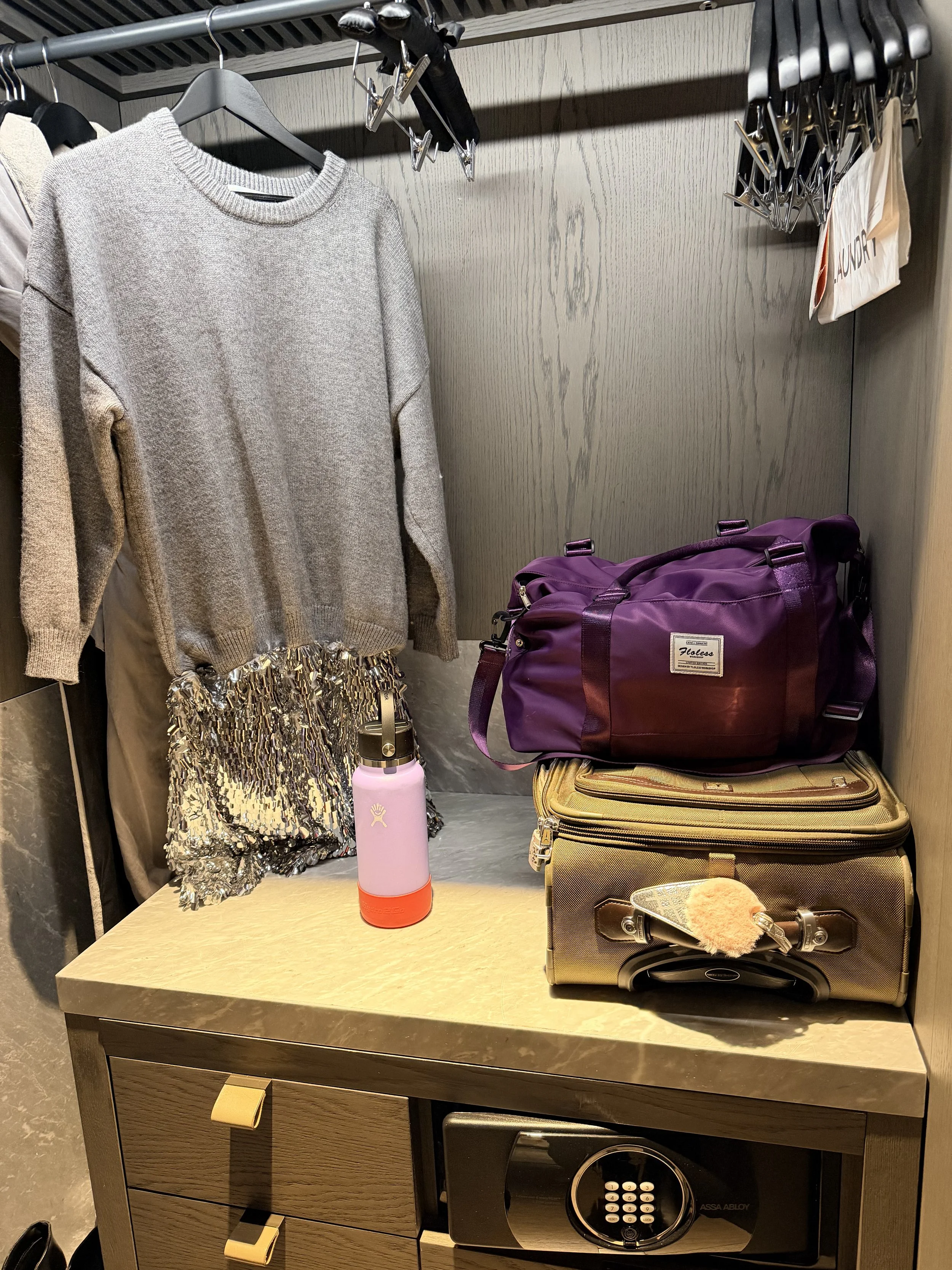 Dress hanging in Alila Hotel Closet with luggage