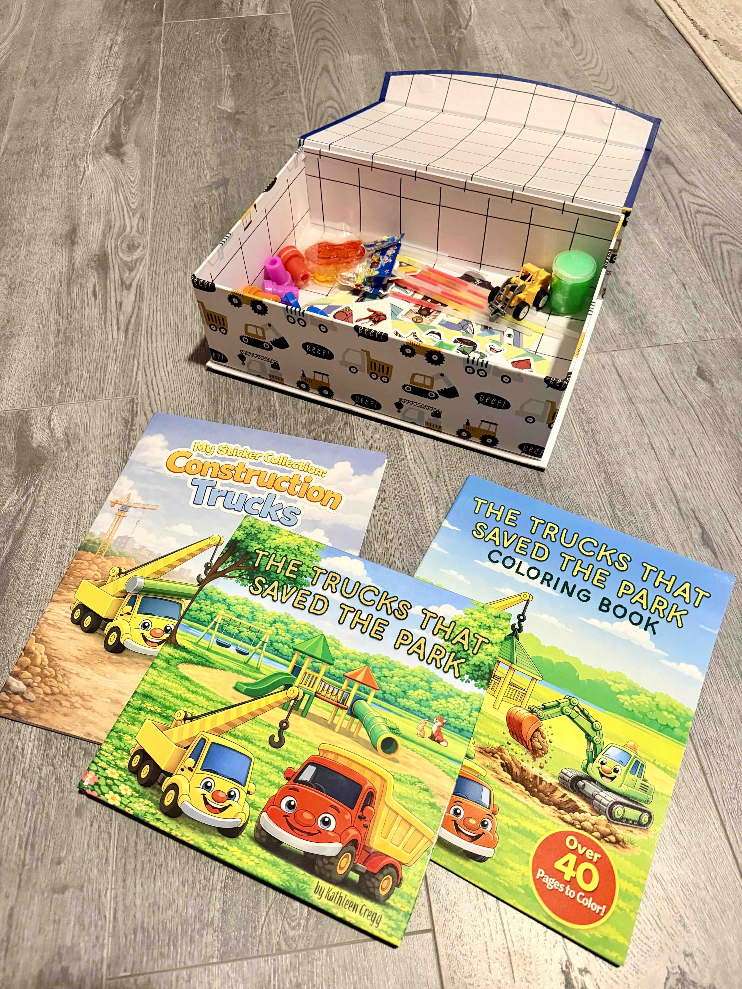 Box of toys and The Trucks that saved series as a prize for completing a potty or chore chart