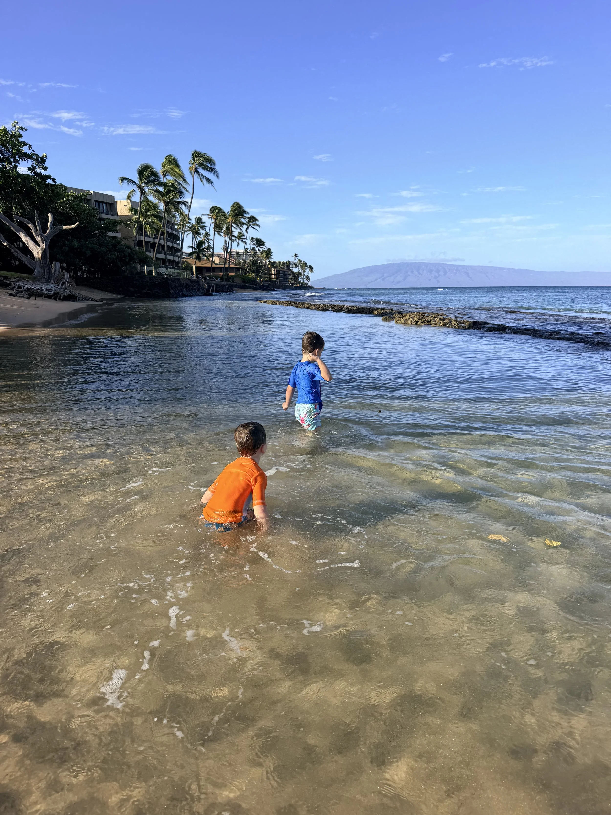 Little boys playing in the ocean at Honokōwai Beach Park