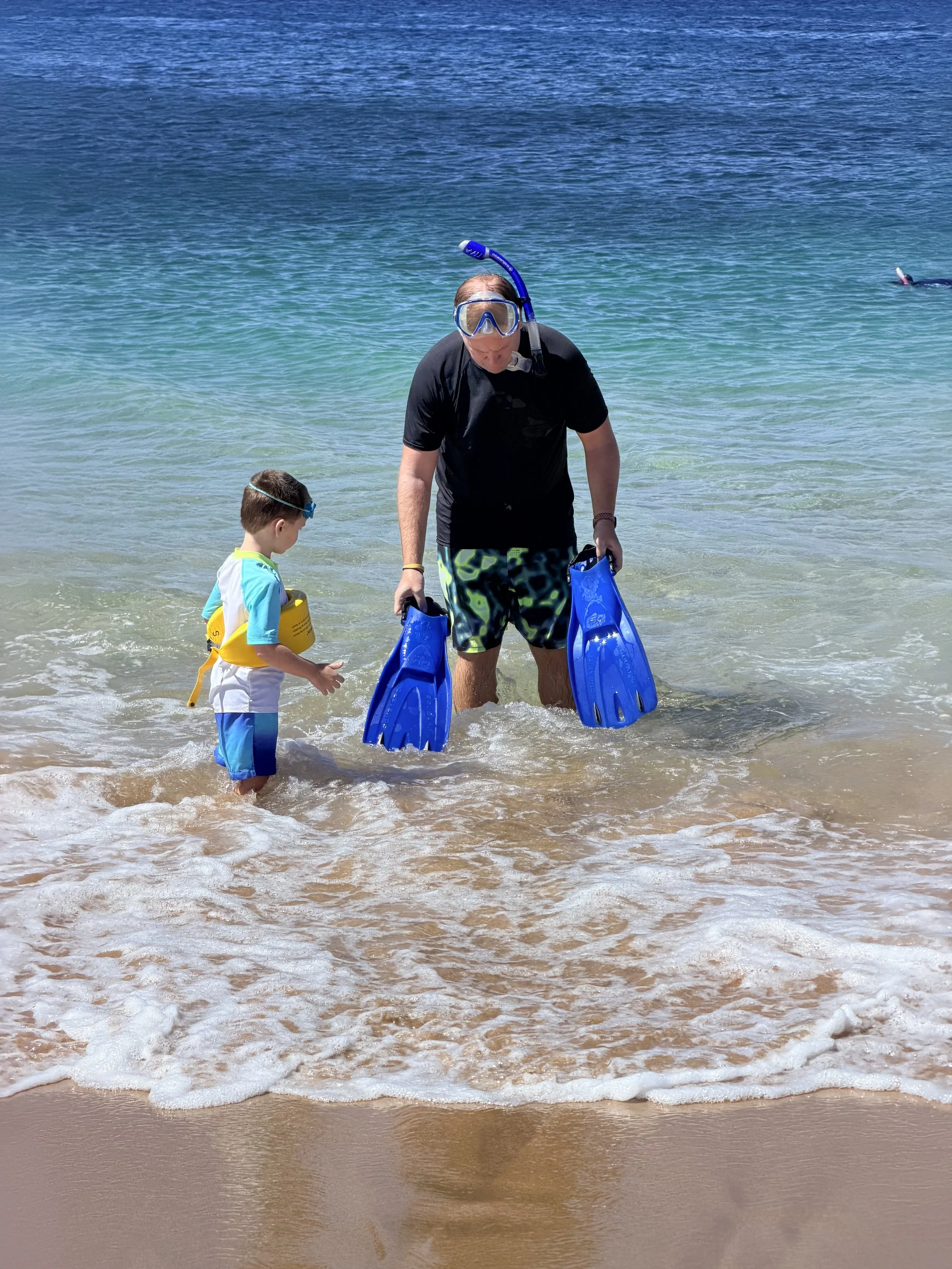 Young boy Snorkeling with Dad at Airport Beach in Maui