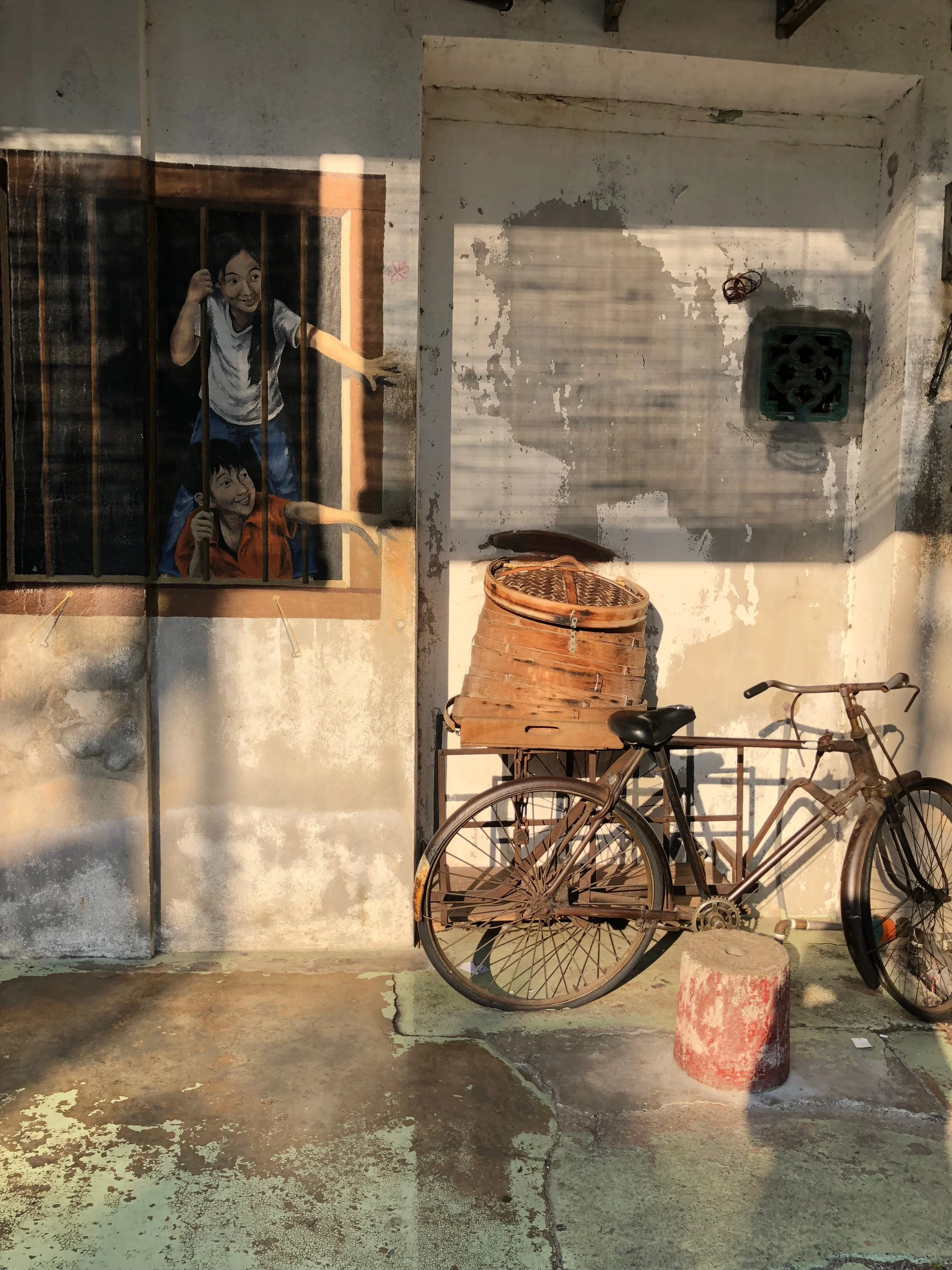 Two children reaching for bao—this mural is called “I Want Bao,” very creative and you can get on the bike.
