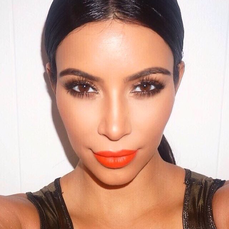 Kim Kardashian wearing coral matte lipstick