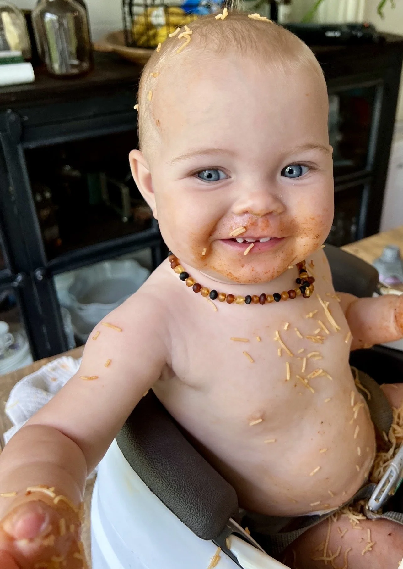 baby with spaghetti all over