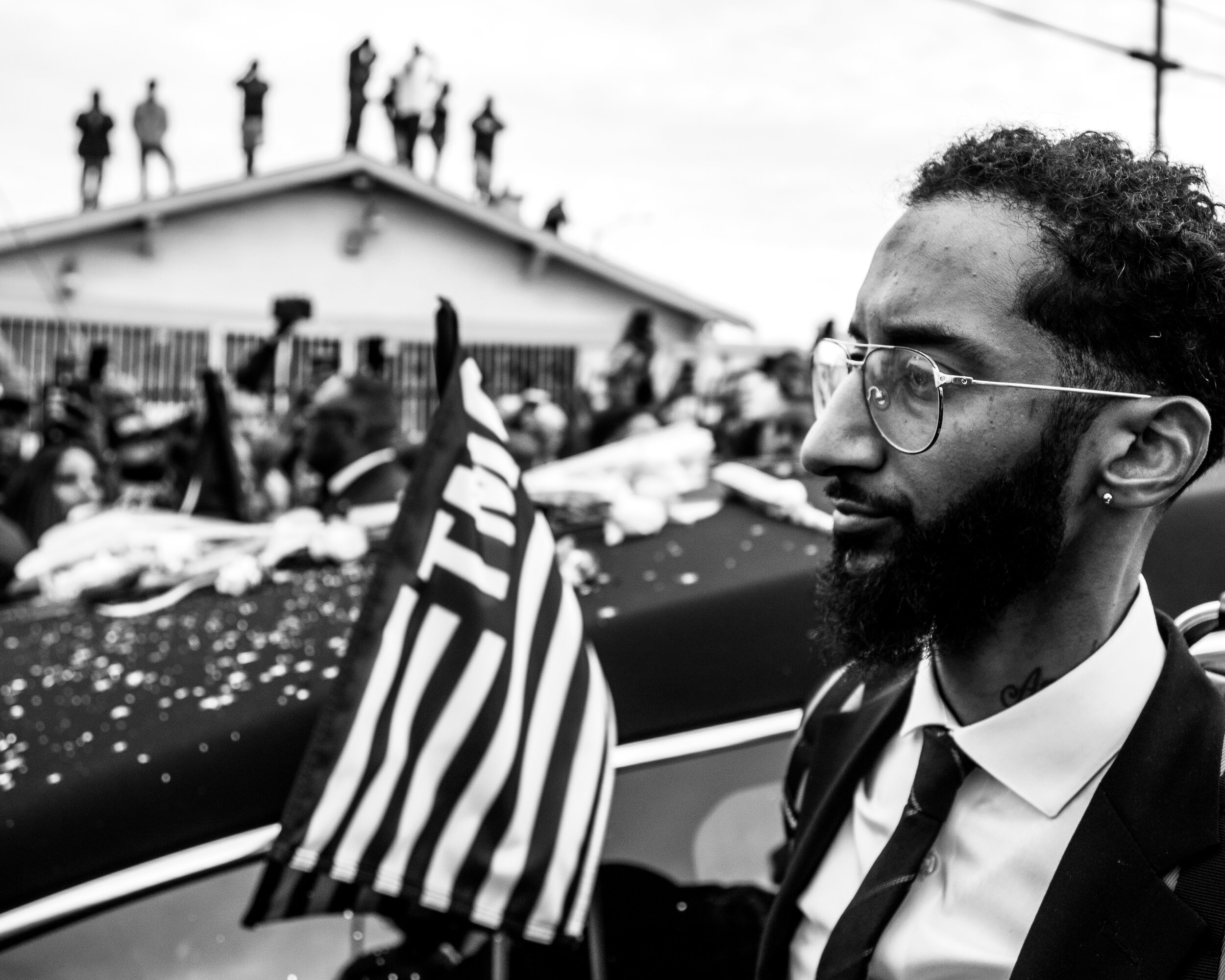  Samiel “Blacc Sam” Asghedom walks down Slauson Avenue next to the hearse carrying his younger brother, Nipsey Hussle, as the funeral procession nears The Marathon Clothing Store. 