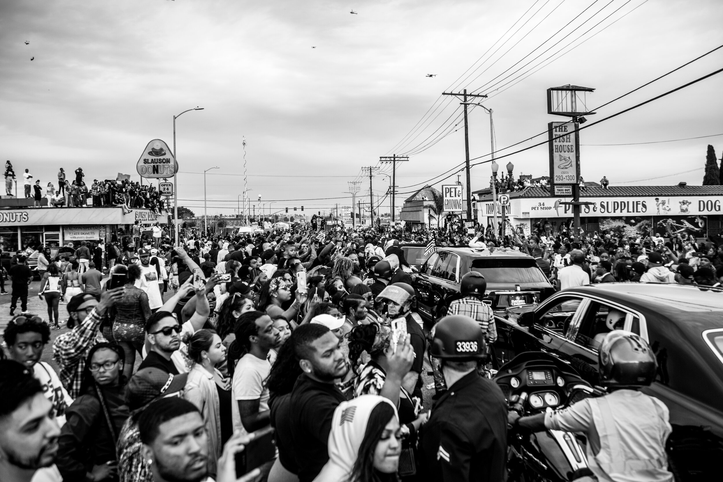  Fans and community members fill the streets as Nipsey Hussle’s funeral procession nears the Marathon Clothing Store. 