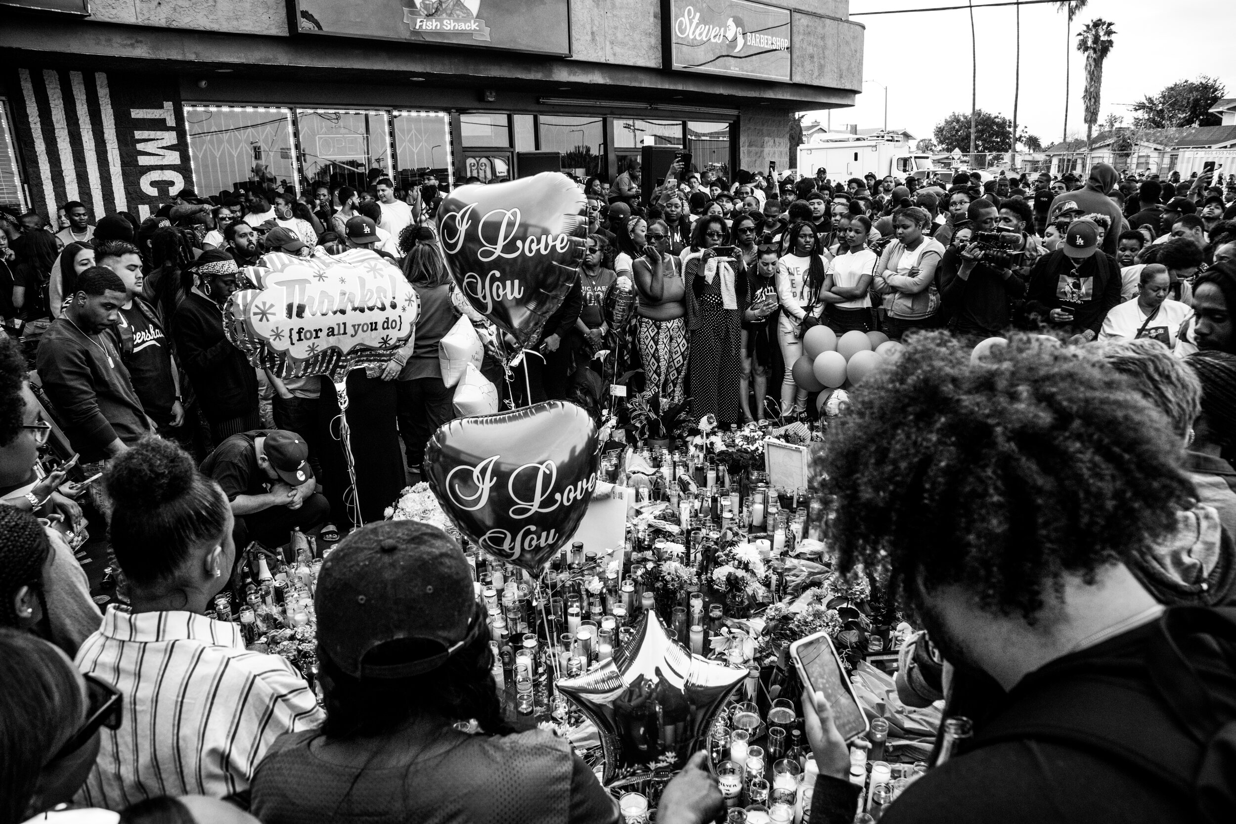  Fans and community members gather at The Marathon Clothing Store, on Slauson and Crenshaw, now named Nipsey Hussle Square, the day after he was slain at that location.  