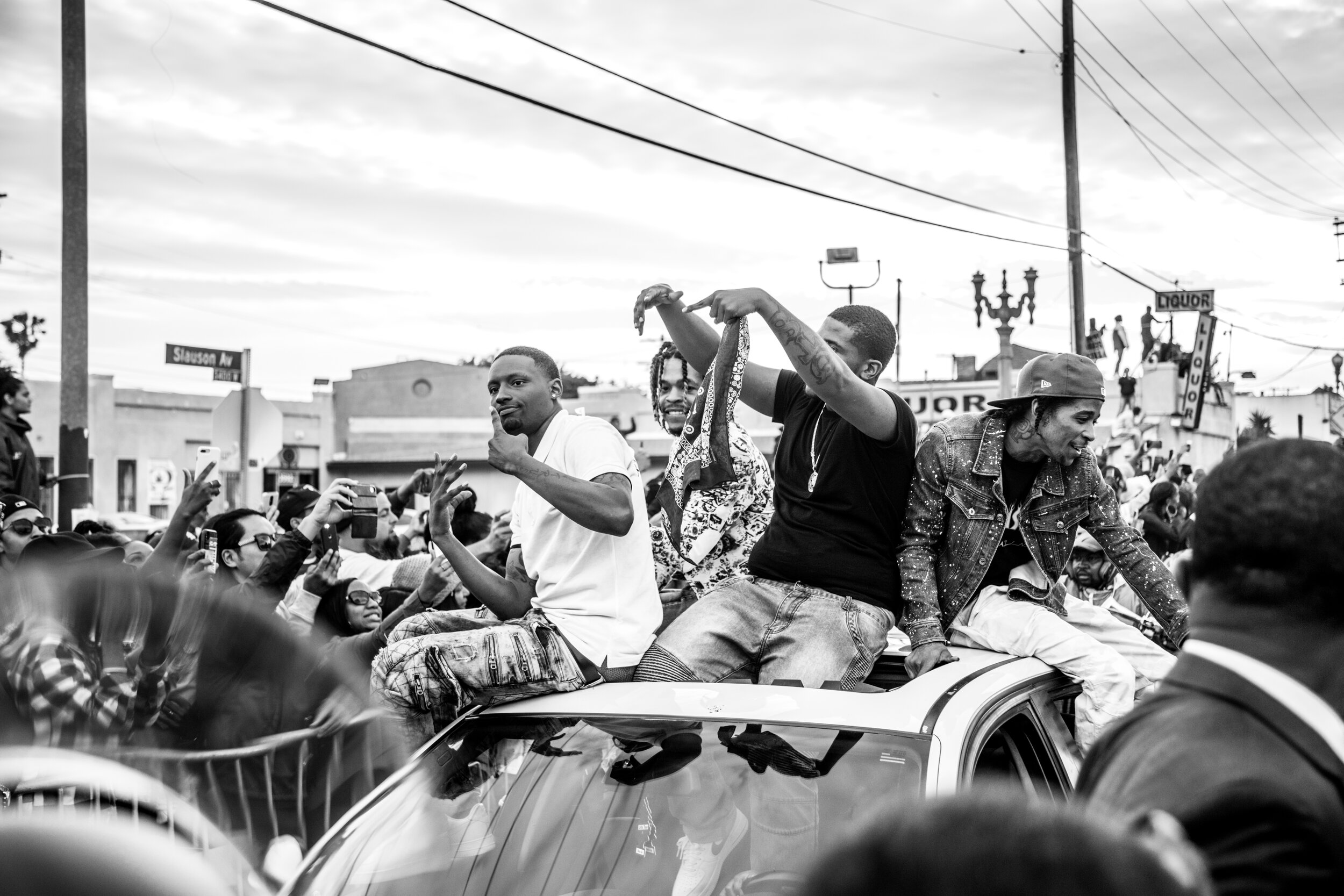  The Nipsey Hussle funeral procession moves down Slauson Avenue near The Marathon Clothing Store on April 11, 2019.  